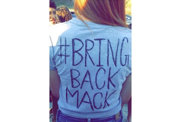 A person wearing a t-shirt that says " bring back mack ".