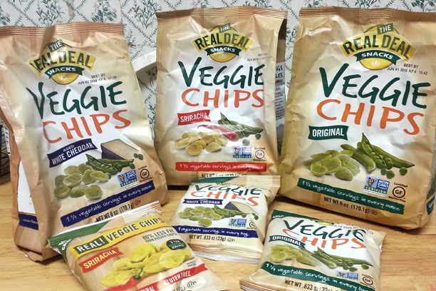 A variety of veggie chips are displayed on the table.