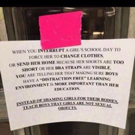 A sign is posted on the door of a house.