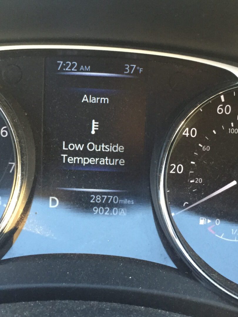 A close up of the dashboard of a car with an alarm