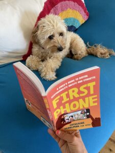 Cute puppy reading First Phone by Catherine Pearlman